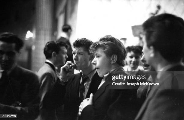 Group of toung teddy boys smoking cigarettes. Original Publication: Picture Post - 7169 - The Truth About Teddy Boys - pub. 1954