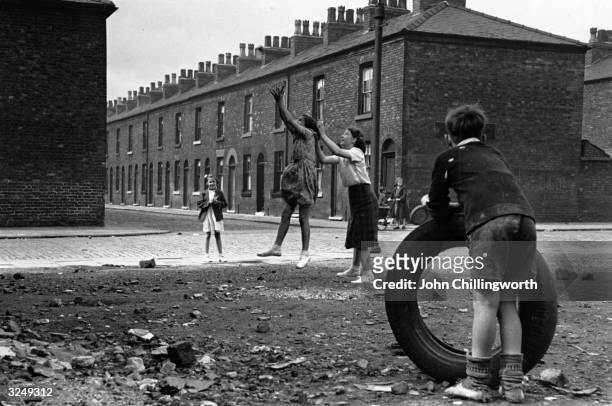 Kids playing in the streets of Salford. Original Publication: Picture Post - 5461 Salford In Wonderland - unpub.