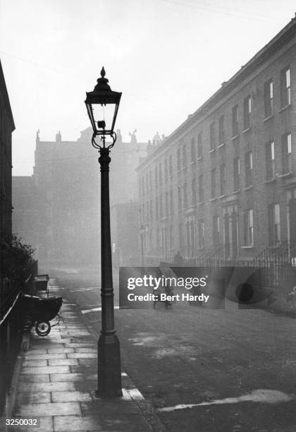 Children playing in a street in Elephant and Castle, London. Original Publication: Picture Post - 4694 - Life In The Elephant - pub. 1949