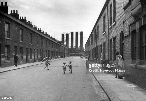 Children playing in a Victorian slum street in Middlesbrough. Original Publication: Picture Post - 2062 - Middlesbrough: The Plan Matures - pub.1945