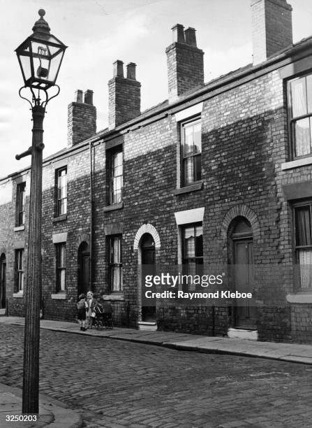 Row of terraced houses at Salford. Original Publication: Picture Post - 8127 - Housing Jungle - pub. 1935