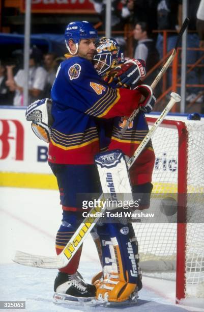 Marc Bergevin hugs goaltender Grant Fuhr of the St. Louis Blues during the Blues 2-1 win over the Los Angeles Kings at the Great Western Forum in...