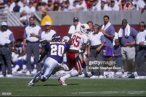 Rob Moore of the Arizona Cardinals is pursued by Dewayne Washington of the Minnesota Vikings during a game at the Sun Devil Stadium in Tempe,...