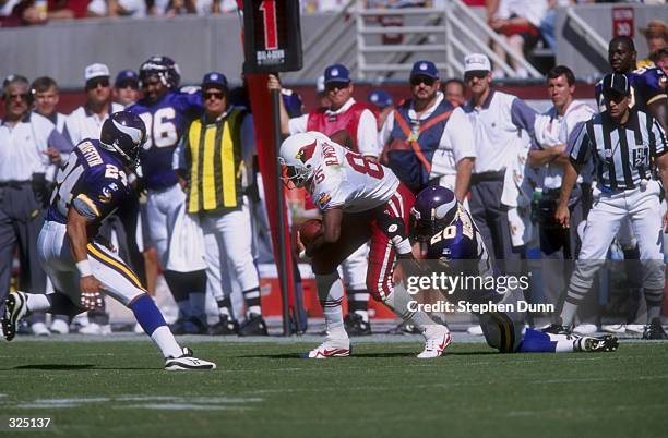 Rob Moore of the Arizona Cardinals is tackled by Dewayne Washington of the Minnesota Vikings during a game at the Sun Devil Stadium in Tempe,...