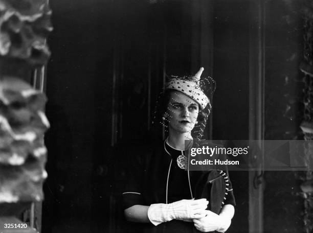 Mrs Charles Sweeney leaves Derby House after attending the display of British fabrics, hosted by Lady Maureen Stanley in aid of British Industry.