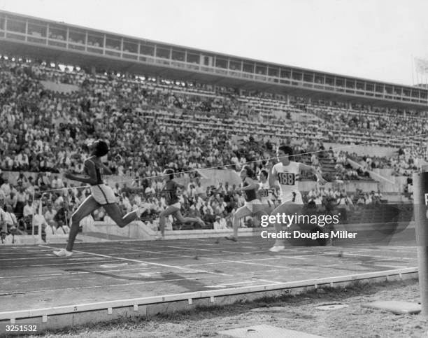 The finish of the 100 metres race at the Olympics in Rome with Wilma Rudolph, taking the gold and Dorothy Hyman, the silver and Italy's G Leone, the...