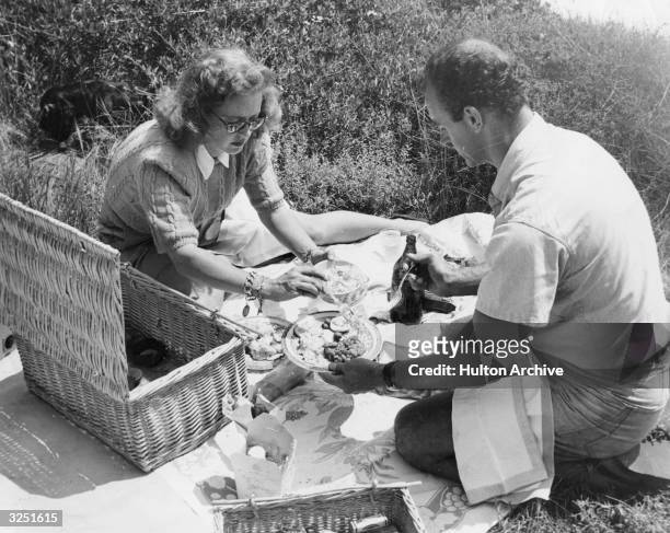 American film actress Bette Davis enjoys a picnic with her husband William Grant Sherry.