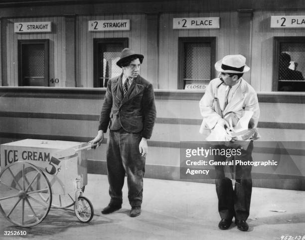 Chico Marx as Tony and Groucho Marx as Doctor Hugo Z Hackenbush in the film 'A Day at the Races', directed by Sam Wood and produced by MGM.