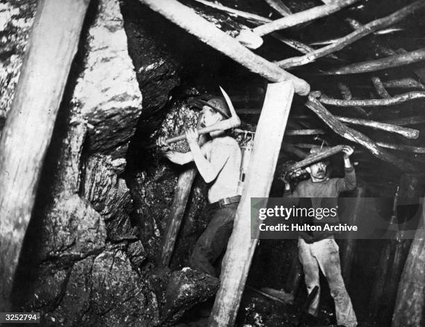 Miners at work on the coal seam, in a French pit.