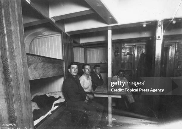 Able Seamen in the forecastle of SS Endurance during preparations for Sir Ernest Shackleton's Antarctic expedition at Millwall Docks in London, July...