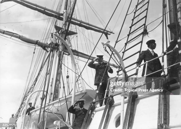 Irish explorer Sir Ernest Shackleton and his second-in-command Mr Wild salute as SS Endurance leaves Millwall Docks for the Antarctic.