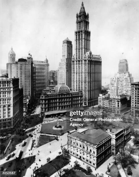 View of upper downtown New York with the Woolworth Building dominating its surroundings. On the left of it is the Transportation Building, to the...