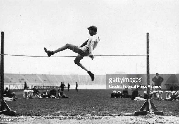 Ray Ewry of the USA in action during the Standing High Jump event at the 1908 London Olympics, for which he won the gold medal. He also won a gold...