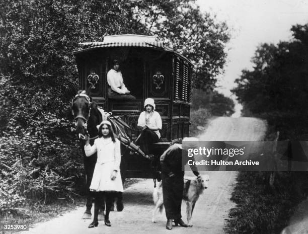 Family touring in a caravan through country roads.