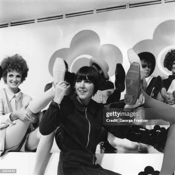 English fashion designer Mary Quant, centre front, at the launch of her 'Quant Afoot' range of boots in fashion colours. The boots are covered in...