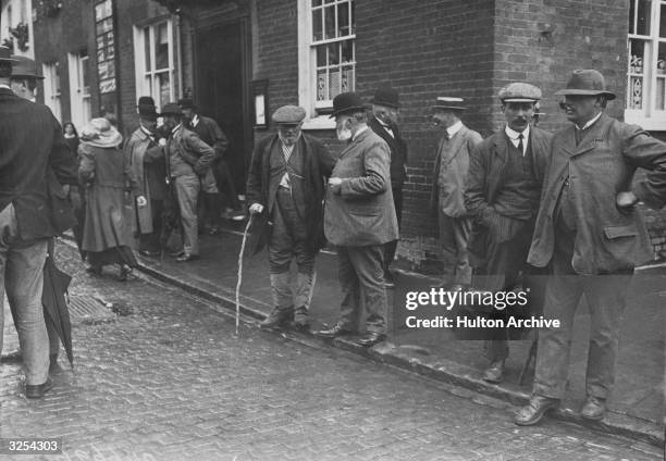 Group of farmers discuss the insurance protest meeting they have just attended in Aylesbury, Buckinghamshire.