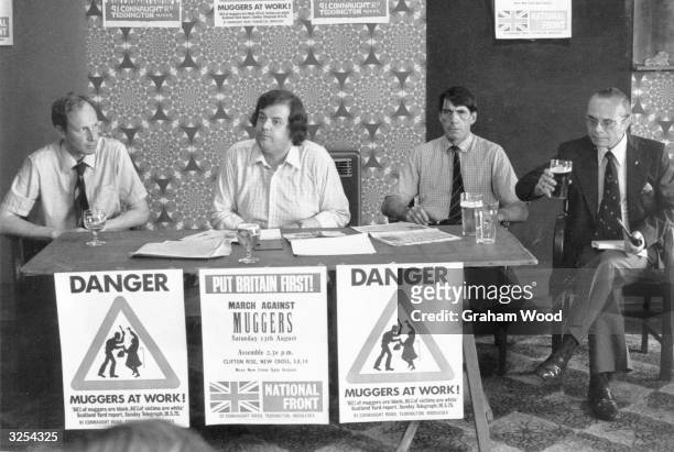 Members of the National Front, including Martin Webb, 2nd left, meet the press at the Ravensbourne Public House, Catford.