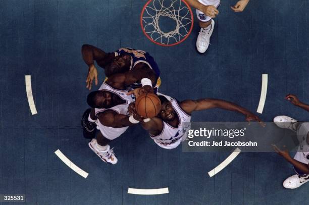 Shaquille O''Neal of the Los Angeles Lakers battles Karl Malone and Bryon Russell of the Utah Jazz for the rebound during the Lakers 99-95 NBA...