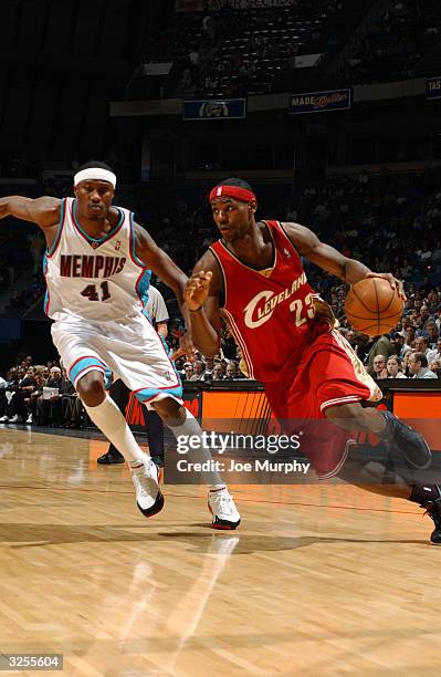 LeBron James of the Cleveland Cavaliers drives to the basket against the defense of James Posey of the Memphis Grizzlies during a game at the Pyramid...