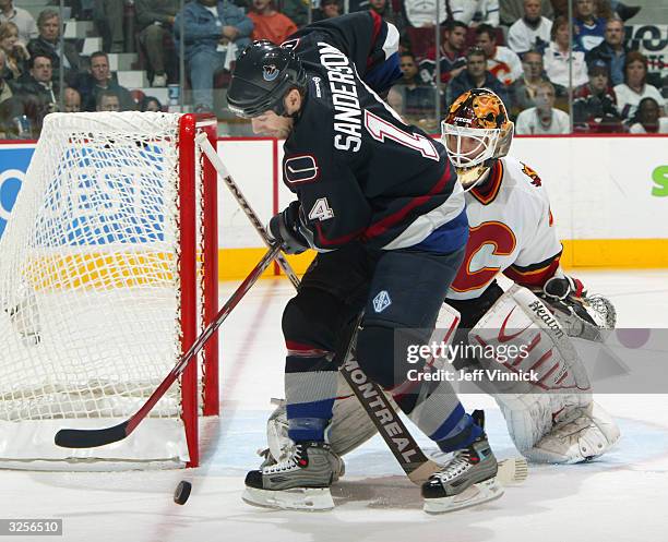 Geoff Sanderson of the Vancouver Canucks looks for a rebound in front of Miikka Kiprusoff of the Calgary Flames during the first period of their...