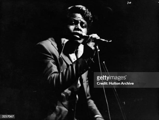 American rhythm and blues and soul singer James Brown sings on stage at the Olympia theater, Paris, France, September 22, 1967.