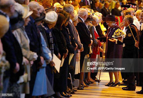 Britain's Queen Elizabeth II hands out maundy money during the Royal Maundy Service held at Liverpool's Anglican Cathedral, 08 April , 2004....
