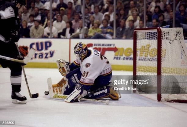 Goaltender Grant Fuhr of the St. Louis Blues stops a shot during the Blues 3-2 NHL Playoff win over the Los Angeles Kings at Kiel Center in St....