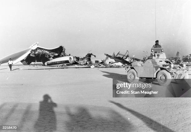 Jordanian troops at Dawsons Field, Jordan, guard the remains of American and Swiss airliners burnt-out by hijackers.