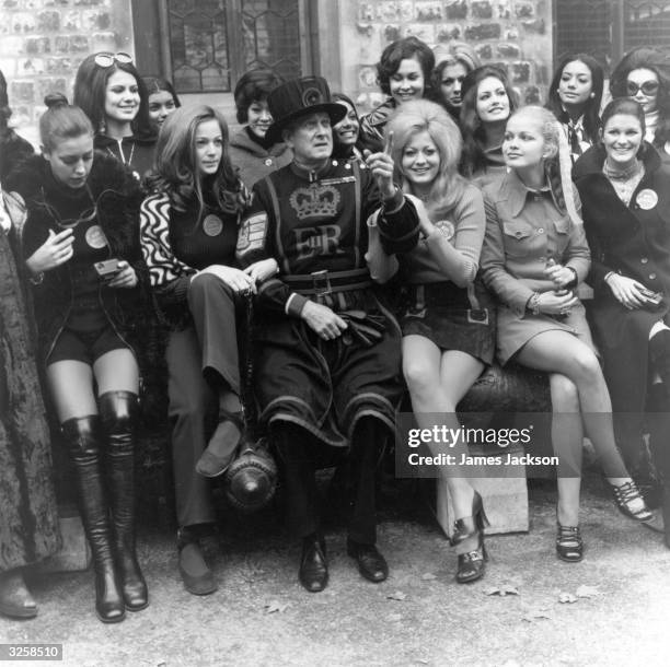 Percy Belson, Tower of London Beefeater, meets the contestants for the 1971 Miss World Contest.