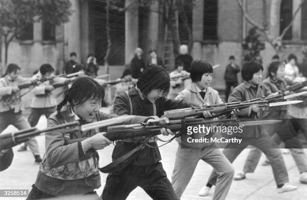In Maoist China, youths from Shanghai, of The Little Red Guard practice their bayonet drill.