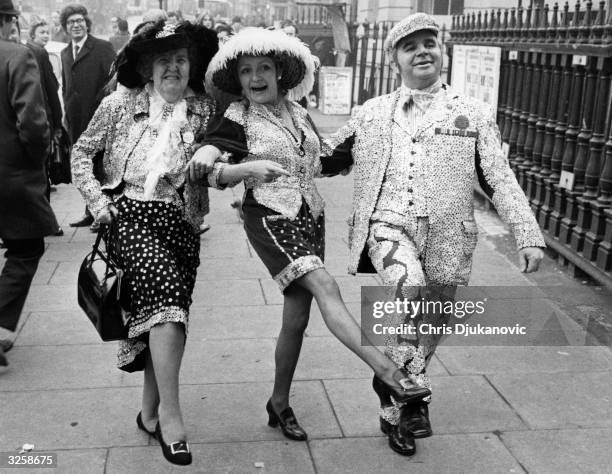 Grace and John Smith, the Pearly King and Queen of South London, seen here with Monica Rose , the Princess of Battersea and Lambeth, dancing down the...