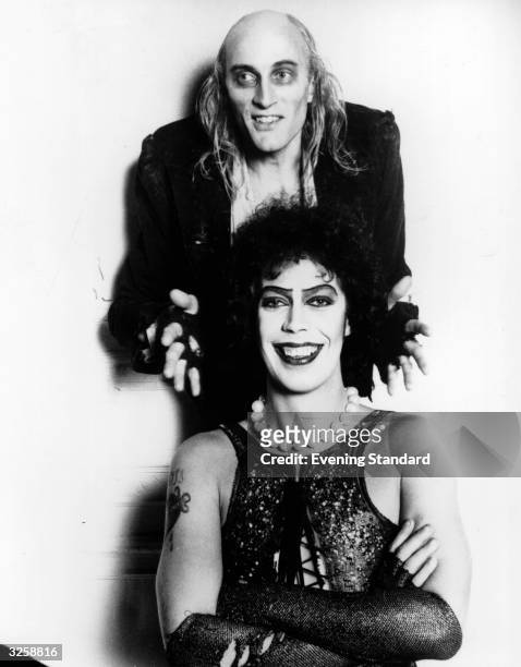 British actor Tim Curry, seated, poses with Richard O'Brien, his co-star in the cult musical 'The Rocky Horror Picture Show', and author of the...