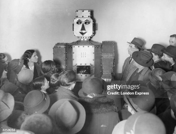 Shoppers admiring a fortune-telling robot at Selfridges Store, London.