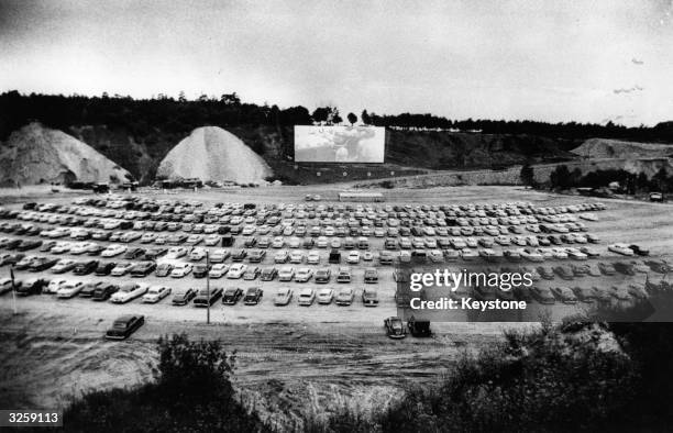 Cars watch the film on the opening night of the first drive-in cinema in Scandinavia, situated outside Copenhagen.