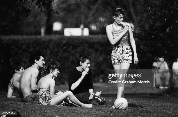 Teenagers enjoy sunny weather in Regent's Park, London.