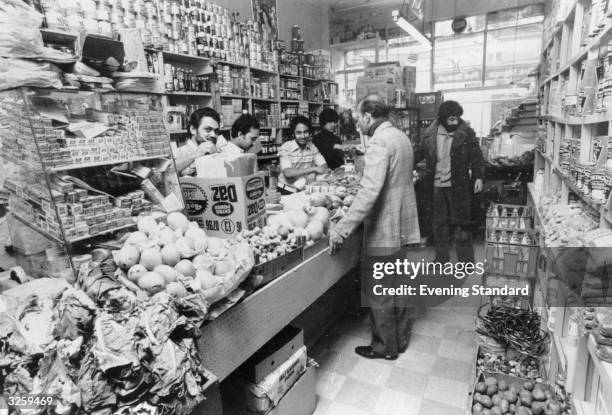 Customers and staff in a grocer's shop in Brick Lane, east London.