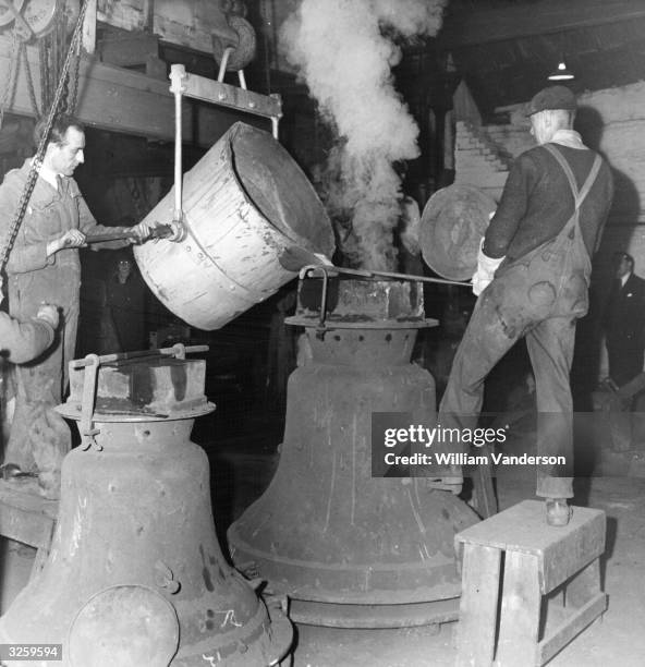 Workers at the Whitechapel Bell Foundry pouring molten metal into a mould which will produce bells for Washington Cathedral. The bells for St Paul's...