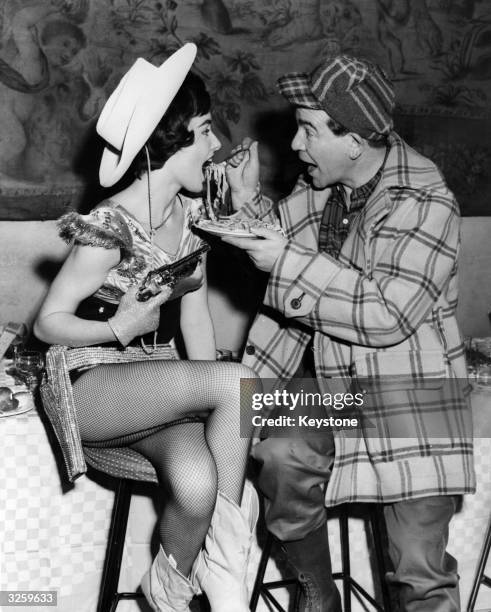 Robert Beatty feeds model Fiona Harding with spaghetti at Britain's first Spaghetti Barbecue, in Chelsea, London. Celebrities from the stage, screen...