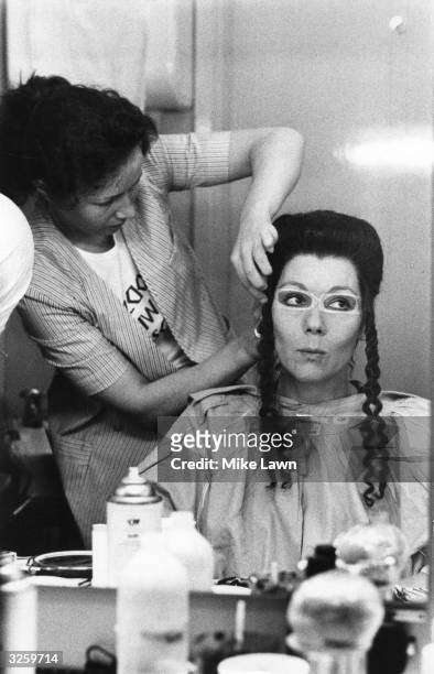 English actress Diana Rigg being made up for her role as Clytemnestra in a production of 'The Choephori' or 'The Libation Bearers', the second play...