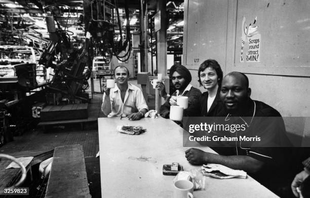 Workers in the first Ford Body Shop at Dagenham have a tea break.