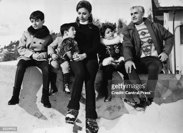 Mohammad Reza Pahlavi, the Shah of Persia, on holiday in St Moritz with his family; Prince Reza , Prince Ali Reza , Empress Farah Diba, Princess...