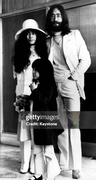 John Lennon , former member of The Beatles, with his wife, Yoko Ono, and her daughter Kyoko at London Airport, where they are leaving for the Bahamas.