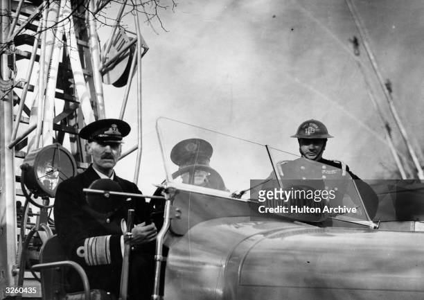 King Haakon VII of Norway attends a display by firemen in North London.