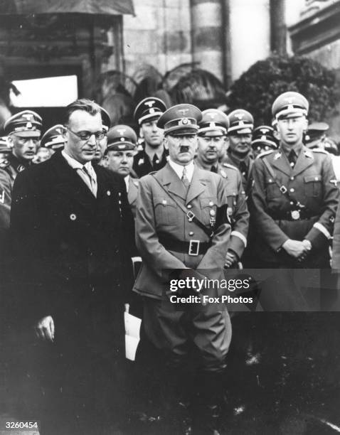 Adolf Hitler standing by Dr. Seyss-Inquart, the last Chancellor of Austria after Hitler's speech in the Heldenplatz, Vienna, which announced the...