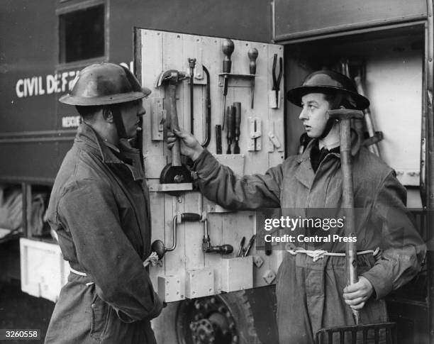 Two National Service Volunteers at a Civil Defence training centre at Taymouth Castle near Aberfeldy in Perthshire, with tools stored in the...