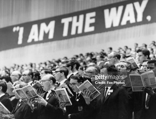 Choir at the Billy Graham evangelist crusade at London's Earls Court sing to 20,000 crowd under the slogan ' I am the way'.