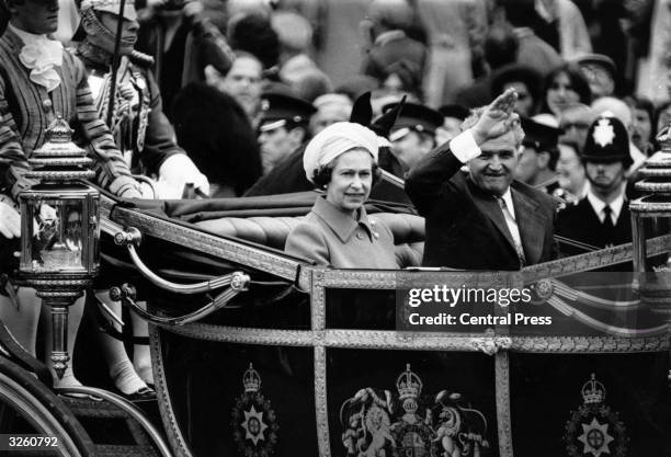 Romanian dictator Nicolae Ceausescu rides in the state carriage with Queen Elizabeth II on his official visit to Britain.