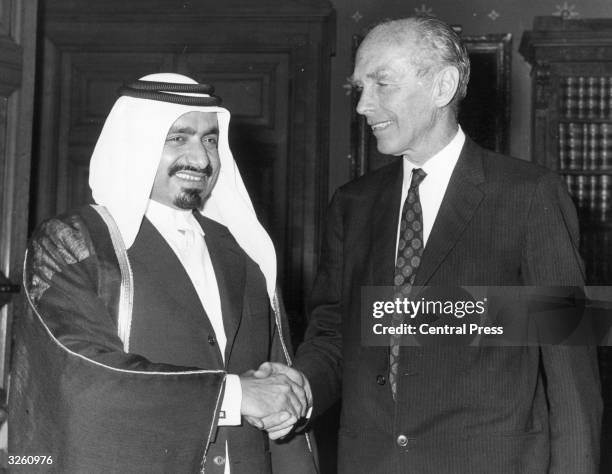 Sheikh Khalifa bin Hamad Al-Thaini, deputy ruler of Qatar in the Persian Gulf, with Sir Alec Douglas-Home, the British Foreign Secretary at the...