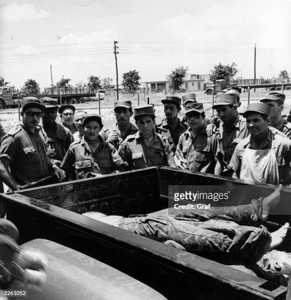 Cuban soldiers stand around a wagon carrying dead soldiers, probably Americans or Brigade 2506 involved in the Bay of Pigs invasion of 1961. |...