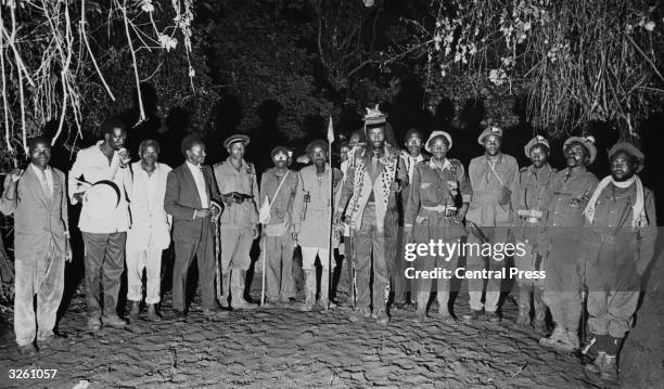 Kenyan revolutionary leader, Field Marshal Musa Mwariama of the Mau Mau movement, and some of his fighters at a forest base, before surrendering...